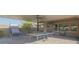 Great outdoor space under a covered patio, featuring foosball, ping pong, and basketball for entertainment at 560 S 197Th Ave, Buckeye, AZ 85326