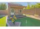Charming backyard playhouse with a well maintained artificial grass putting green at 560 S 197Th Ave, Buckeye, AZ 85326