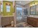 Bathroom featuring an enclosed shower with a glass door, custom cabinets, and a decorative mirror at 560 S 197Th Ave, Buckeye, AZ 85326