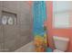 Bathtub and shower with a colorful shower curtain and a built-in shelf at 560 S 197Th Ave, Buckeye, AZ 85326