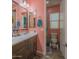 Bathroom with a double vanity, a large mirror, and wood-look flooring at 560 S 197Th Ave, Buckeye, AZ 85326