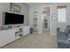 Bedroom with a large TV, blue sofa, and doorway into another room at 560 S 197Th Ave, Buckeye, AZ 85326