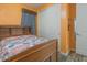 Bedroom with a wooden bed, closet with sliding doors, and orange walls at 560 S 197Th Ave, Buckeye, AZ 85326