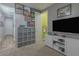 Comfortable carpeted bedroom with gray walls, decorated with vibrant artwork, and complete with modern entertainment setup at 560 S 197Th Ave, Buckeye, AZ 85326