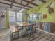 Unique dining room with wooden table, benches, and chairs with natural light and rustic decor at 560 S 197Th Ave, Buckeye, AZ 85326