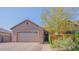 Inviting single-story home featuring a brick-paved driveway and mature tree in the front yard at 560 S 197Th Ave, Buckeye, AZ 85326