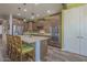 Spacious kitchen featuring an island with bar seating, stainless steel appliances, and wooden cabinets at 560 S 197Th Ave, Buckeye, AZ 85326