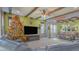 Cozy living room featuring a fireplace, large TV, rustic decor, and view to dining area at 560 S 197Th Ave, Buckeye, AZ 85326