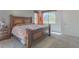 Cozy bedroom featuring a queen bed, side tables, and a large window providing natural light at 560 S 197Th Ave, Buckeye, AZ 85326
