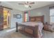 Comfortable bedroom with a large bed, side tables, and natural light. Bathroom with closet view at 560 S 197Th Ave, Buckeye, AZ 85326