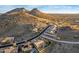 Picturesque aerial view of a home with pool, desert landscaping, and majestic mountain backdrop at 6022 W Fetlock Trl, Phoenix, AZ 85083