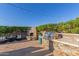 Inviting backyard features an outdoor grill, built-in fireplace, elegant seating area, and string lights at 6022 W Fetlock Trl, Phoenix, AZ 85083