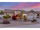 Attractive single-story home showcasing desert landscaping, an American flag, and a three-car garage at 6022 W Fetlock Trl, Phoenix, AZ 85083
