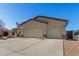 Large three-car garage with extended driveway on a sunny day at 6022 W Fetlock Trl, Phoenix, AZ 85083