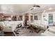 Open-concept living room with hardwood floors, white sofas, and a view of the kitchen at 6022 W Fetlock Trl, Phoenix, AZ 85083