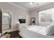 Bright main bedroom featuring a ceiling fan, a window and a bathroom entrance at 6022 W Fetlock Trl, Phoenix, AZ 85083