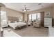 A serene bedroom features a king-size bed, natural light, and plush seating, creating a relaxing retreat at 6022 W Fetlock Trl, Phoenix, AZ 85083