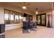 Covered patio with bar-style seating, ceiling fans, and views of the backyard at 6022 W Fetlock Trl, Phoenix, AZ 85083