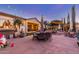 Stamped concrete patio featuring an outdoor dining set and string lights for ambiance at 6022 W Fetlock Trl, Phoenix, AZ 85083