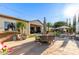 Stamped concrete patio with dining area featuring an outdoor kitchen and pool at 6022 W Fetlock Trl, Phoenix, AZ 85083