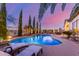 Backyard pool with poolside seating, rock waterfall, and lush greenery at 6022 W Fetlock Trl, Phoenix, AZ 85083