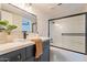 Updated bathroom with a framed mirror, stylish vanity, and a tiled shower at 6565 N 19Th Ave # 59, Phoenix, AZ 85015