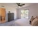 Sunlit bedroom with a dresser, balcony access, and attached bathroom, offering comfort and convenience at 6565 N 19Th Ave # 59, Phoenix, AZ 85015