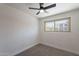 Bright bedroom featuring a ceiling fan, carpet flooring, and a window at 6565 N 19Th Ave # 59, Phoenix, AZ 85015