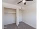 Carpeted bedroom with a ceiling fan, closet, and a neutral color palette at 6565 N 19Th Ave # 59, Phoenix, AZ 85015