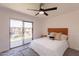 Bright bedroom featuring a ceiling fan, modern decor, and a balcony at 6565 N 19Th Ave # 59, Phoenix, AZ 85015