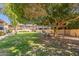 Inviting community lawn area with mature trees and seating, perfect for relaxing outdoors at 6565 N 19Th Ave # 59, Phoenix, AZ 85015