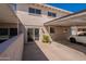 This home features a carport, painted brick, a rear patio, and a sliding glass door at 6565 N 19Th Ave # 59, Phoenix, AZ 85015