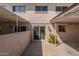 This home has a carport, painted brick, a rear patio, a sliding glass door, and low maintenance landscaping at 6565 N 19Th Ave # 59, Phoenix, AZ 85015