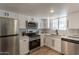 Clean kitchen featuring stainless steel appliances, white cabinetry, and modern subway tile backsplash at 6565 N 19Th Ave # 59, Phoenix, AZ 85015