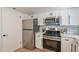 Modern kitchen featuring stainless steel appliances, white cabinets, and subway tile backsplash at 6565 N 19Th Ave # 59, Phoenix, AZ 85015