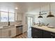 Bright kitchen with stainless steel appliances, white cabinetry, and modern pendant lighting near the dining area at 6565 N 19Th Ave # 59, Phoenix, AZ 85015