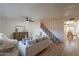 Bright living room with wood floors, modern fan and staircase at 6565 N 19Th Ave # 59, Phoenix, AZ 85015