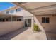 Cozy rear patio with painted walls, a brick facade, a sliding glass door, and a covered patio at 6565 N 19Th Ave # 59, Phoenix, AZ 85015
