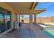 Covered back patio including a built-in BBQ area, swimming pool, and a shaded seating area at 6904 W Golden Ln, Peoria, AZ 85345