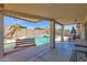 Covered backyard patio with a porch swing that overlooks a refreshing inground swimming pool at 6904 W Golden Ln, Peoria, AZ 85345