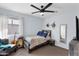 Charming bedroom with a ceiling fan, full-sized bed, and light blue painted walls at 6904 W Golden Ln, Peoria, AZ 85345
