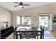 Charming dining area with dark wood furniture, bright lighting, and sliding glass door leading to the backyard at 6904 W Golden Ln, Peoria, AZ 85345