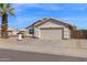 Charming home featuring a well-manicured lawn, two-car garage, and a welcoming entrance at 6904 W Golden Ln, Peoria, AZ 85345