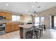 Open kitchen with stainless steel appliances, center island, and adjacent dining area with backyard access at 6904 W Golden Ln, Peoria, AZ 85345