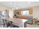 Well-lit kitchen featuring a center island with seating, stainless steel appliances, and ample counter space at 6904 W Golden Ln, Peoria, AZ 85345