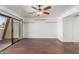 Bright living room with a ceiling fan, hardwood floors, and sliding glass doors to the outside at 705 W 13Th St, Tempe, AZ 85281