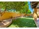 Lush backyard featuring well-maintained artificial turf and mature trees at 7330 E Palo Verde Dr # 1, Scottsdale, AZ 85250