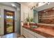 Bathroom featuring a marble countertop, custom basin sink, and luxurious shower at 7330 E Palo Verde Dr # 1, Scottsdale, AZ 85250