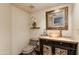 Elegant powder room featuring a unique vessel sink, decorative mirror, and modern fixtures at 7330 E Palo Verde Dr # 1, Scottsdale, AZ 85250