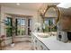 Lavish bathroom featuring ornate mirror, designer vanity, and sunlit window at 7330 E Palo Verde Dr # 1, Scottsdale, AZ 85250